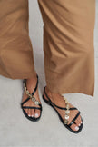 SELENE BLACK CROSS-STRAP FLAT WOMEN’S SANDALS WITH GOLD ACCENT