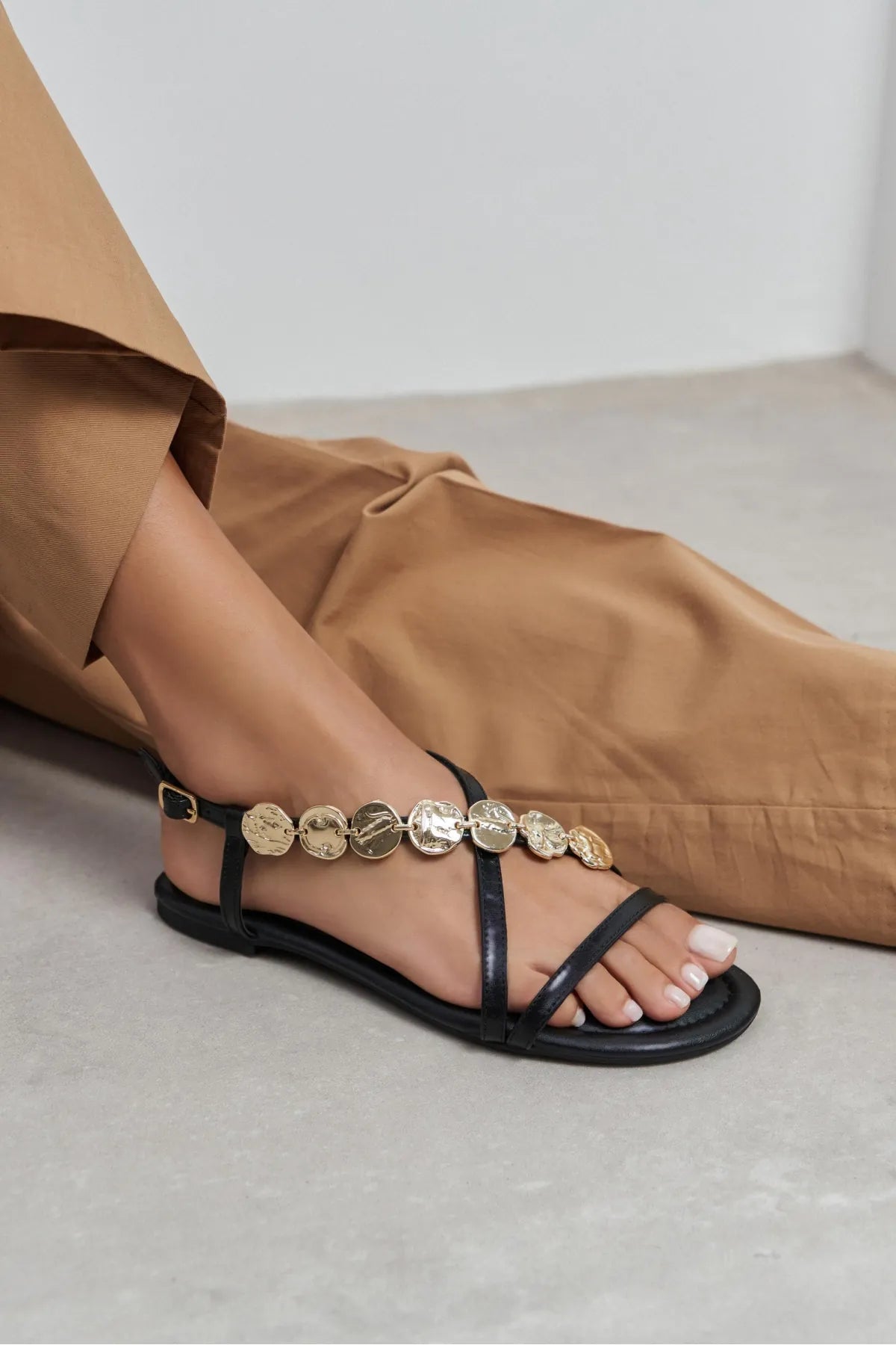 SELENE BLACK CROSS-STRAP FLAT WOMEN’S SANDALS WITH GOLD ACCENT