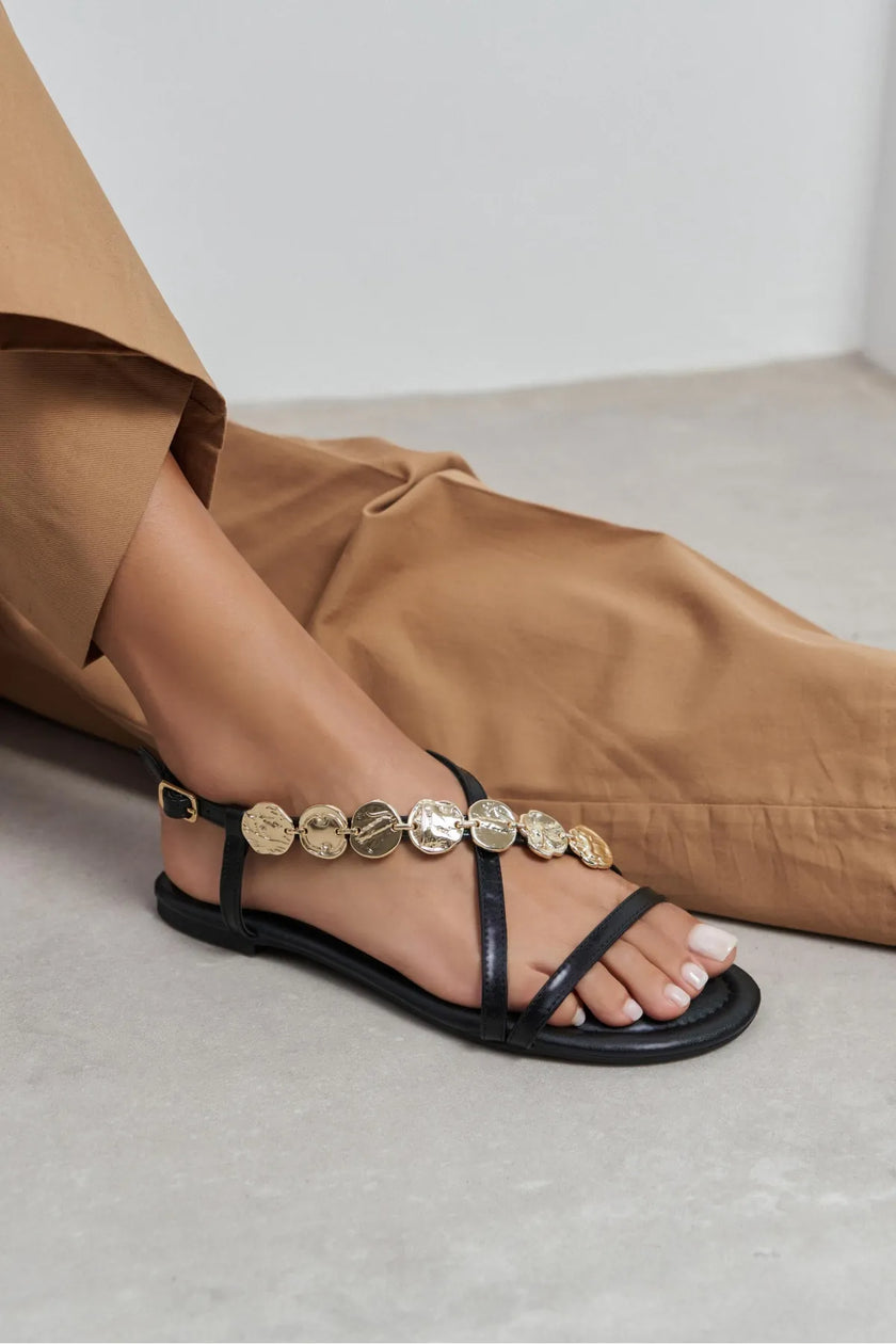 SELENE BLACK CROSS-STRAP FLAT WOMEN’S SANDALS WITH GOLD ACCENT