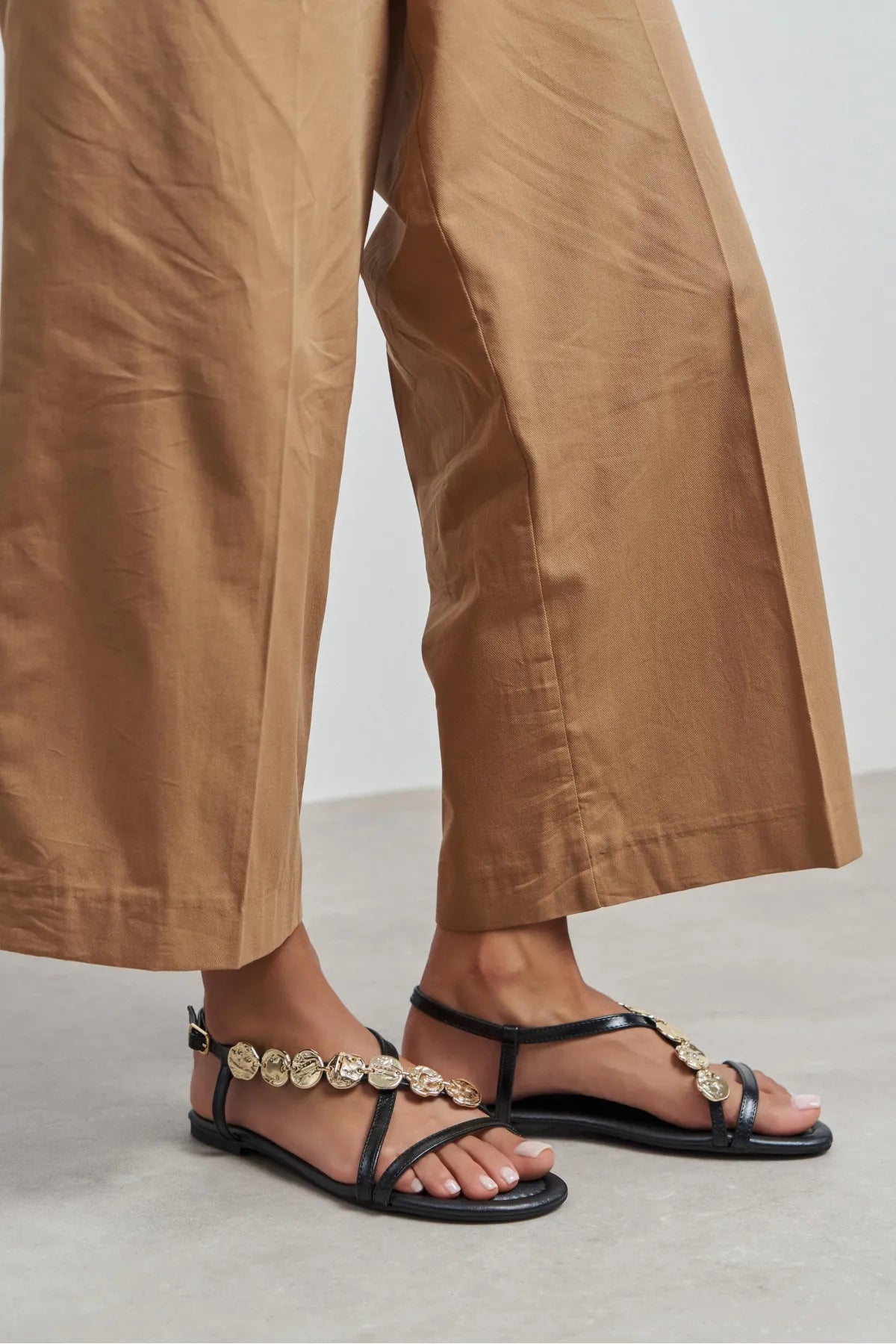 SELENE BLACK CROSS-STRAP FLAT WOMEN’S SANDALS WITH GOLD ACCENT